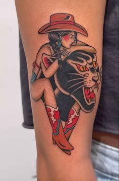 a person with a tattoo on their arm and a cat wearing a cowboy's hat