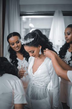 the bride is getting ready for her big day at the wedding ceremony with her bridal party