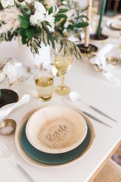 a white table topped with plates and glasses