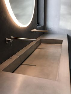 a bathroom with a sink, mirror and lights on the wall next to each other