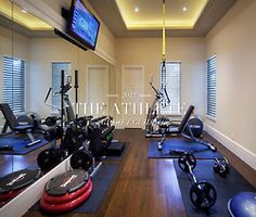 an exercise room with treadmills, machines and television on the wall that says back at it january mood