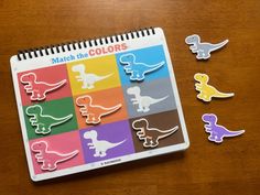 a calendar with different colored dinosaurs on it