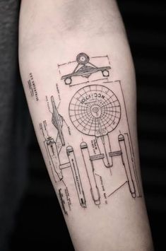 a man's arm with a drawing on it that has scissors and other tools