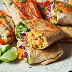 a plate topped with burritos covered in toppings