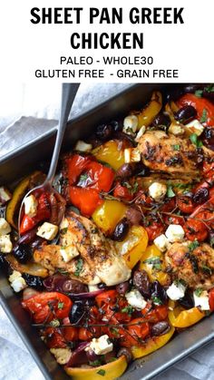 a pan filled with chicken and vegetables on top of a white table cloth next to a fork