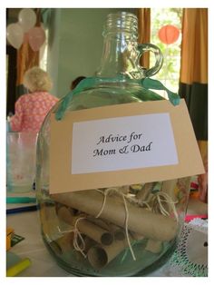 a glass bottle filled with lots of paper and twine on top of a table