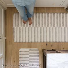 a person standing on top of a kitchen floor