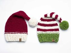 two knitted hats with pom - poms on them, one is red and the other is green