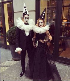 two people dressed up in costumes standing next to each other