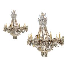 two antique chandeliers with candles on them