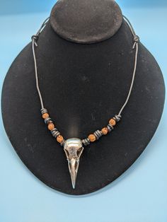 Embrace a blend of age-old tradition and modern flair with our Silver Raven necklace. This 22-inch necklace, featuring adjustable Barrel Sliding Knots, can be easily customized to fit your style. At its core lies an intricately designed Pewter Raven charm, symbolic of transformation and mystery, complemented by Navajo Ghost Beads that offer protection and a connection to the spiritual world. The high-quality leather ensures durability and comfort, making it perfect for any occasion. Each necklace is handcrafted with care, reflecting cultural heritage and contemporary design. This unique piece not only adds elegance to your style but also embodies a deep spiritual significance. Support a veteran and Native American-owned small business by adding this exquisite necklace to your collection to Rustic Beaded Necklace For Festivals, Rustic Adjustable Beaded Necklaces For Festivals, Rustic Adjustable Beaded Necklaces, Nickel Free Southwestern Style Necklace With Round Beads, Nickel-free Southwestern Necklace With Round Beads, Festival Metal Necklace With Adjustable Cord, Southwestern Style Jewelry With Adjustable Chain, Southwestern Oxidized Adjustable Jewelry, Southwestern Jewelry With Adjustable Chain