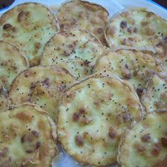 small pizzas are arranged on a white plate