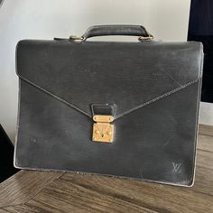 Pre Owned Louis Vuitton Epi Leather Briefcase. Used Condition. The Snap Works By Squeezing The Two Little Buttons Together. There Are Two Ripped Gussets One On Each Side. Not A Complete Tear. Clean Interior. There Is Some Signs Of Rubbing And Peeling. The Exterior Pocket Has Major Peeling And A Slight Sticky Feeling. Handle Is Good Condition With Some Creasing In Leather. Some Tarnishing On The Gold Hardware. Multiple Little Marks On The Epi Leather Exterior Which Aren’t Very Visible To Eye. Corner Rubbing And Wear. Gussets Should Be A Easy Fix. Date Code Reads Mi0967. Authentic. It Is Kind Of Heavy I Would Say Around 2-3lbs. Designer Formal Briefcase With Branded Hardware, Designer Business Briefcase With Branded Hardware, Black Briefcase With Gold-tone Hardware For Travel, Luxury Black Briefcase With Gold-tone Hardware, Black Rectangular Briefcase With Gold-tone Hardware, Louis Vuitton Mens Briefcase, Eye Corner, Snap Words, Luxury Black Leather-lined Briefcase