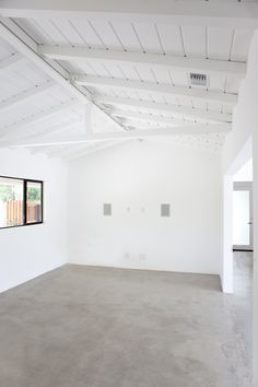 an empty room with white walls and ceilings