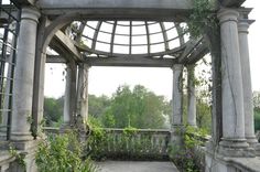 an old gazebo with vines growing on it