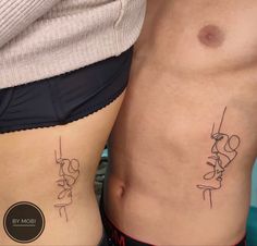 two people with tattoos on their stomachs