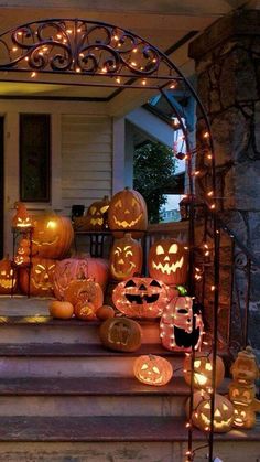 pumpkins and jack - o'- lanterns are lit up on the front steps