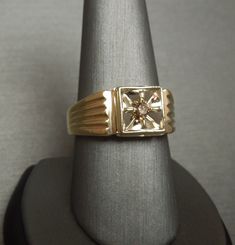 Vintage Circa 1960 Constructed of 14KT White & Yellow Gold Containing 1 Genuine Earth-Mined Round Brilliant cut Natural Fancy Cognac Colored Diamond weighing approximately 0.12 carats Diamond measuring approximately 2.8mm in diameter I2 Clarity Secured in a 4-Prong Starburst Style 14KT White Gold Square Illusion section Top section of ring measuring 10mm in length & about 5mm high when on the finger *Refer to photo of face of ring next to U.S. DIME for size reference.. Inside shank: 14K Collectible Yellow Gold Brilliant Cut Diamond Ring, Collectible Brilliant Cut Yellow Gold Diamond Ring, Classic Diamond Signet Ring Collectible, Collectible Classic Diamond Signet Ring, Vintage Yellow Gold Diamond Signet Ring, Collectible Yellow Gold Rings With Diamond Accents, Vintage Yellow Gold Signet Ring With Center Stone, Vintage 14k Gold Signet Ring With Center Stone, Vintage Gold Signet Ring With Single Diamond