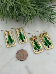 Introducing our fabulous and festive Christmas Tree Earrings. Hand beaded using premium seed beads and golden brass accents, these playful and gorgeous earrings add an extra touch of charm to your holiday ensemble. The perfect gift option, these eye-catching earrings make for an ideal stocking stuffer or a thoughtful present for a loved one. With these festive holiday earrings, you're sure to make a statement and spread joy wherever you go! Choice of with bow or without ✔️1 5/8 inches long & 5/8 Handmade Festive Earrings For Christmas, Handmade Beaded Earrings For Holiday Party, Gift Brass Beaded Earrings With Round Beads, Nickel-free Jewelry For Festive Holidays, Nickel-free Jewelry For Festive Holiday, Holiday Party Handmade Beaded Earrings, Gold Beaded Dangle Earrings For Festive Occasions, Holiday Festive Nickel-free Jewelry, Christmas Gold Beaded Earrings