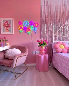 a bedroom with pink walls and decorations on the wall, along with a white bed