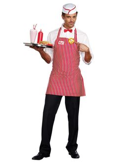 a man in an apron holding a tray with cakes on it