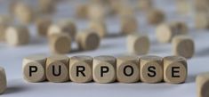 wooden blocks spelling the word perhapss in front of a group of smaller cubes