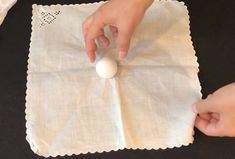 a person placing an egg on top of a napkin