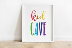 a white framed poster with the words'ridd cave'painted in rainbow colors