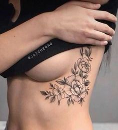 a woman with a flower tattoo on her stomach