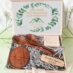 two wooden spoons in a gift box that says new home, new beginnings and new memories