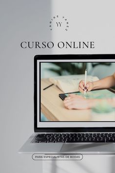 an open laptop computer sitting on top of a wooden desk next to a white wall