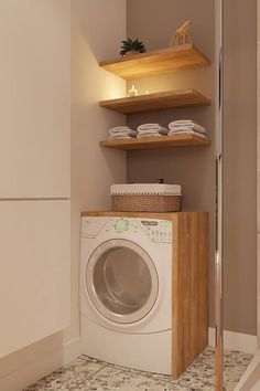 a washer and dryer in a bathroom with shelving above it's doors