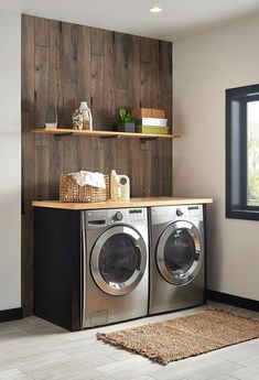 a washer and dryer in a room with wood paneling on the wall