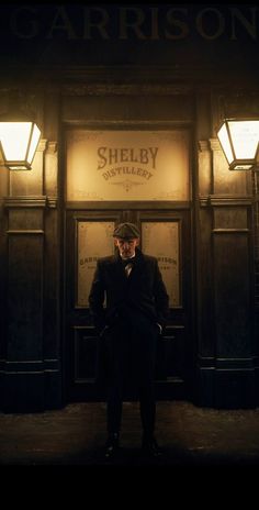 a man standing in front of a building at night