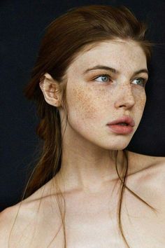 a woman with freckles on her face and shoulder