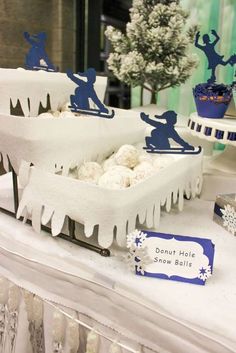 a table topped with lots of snow covered cakes