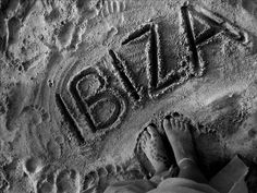 someone's feet in the sand with their name written on it