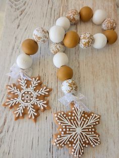 an assortment of cookies and decorations on a wooden table, including snowflakes