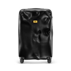 a black piece of luggage with a yellow sticker on the front and bottom part