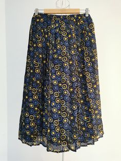 Vintage abstract print pleated skirt from the 1990's. Women's high waist skirt with an abstract print in shades of blue, yellow and olive green. Skirt has an elastic waist. Falls free below the knees. Fully lined. Material: 100% Polyester Size: 48 DE, which is 18 US or XL. To be sure this item would fit you, please look at the measurements below. Approximate Measurements (taken while skirt is lying flat, double waist): Waist (double that): Stretches from 17 inches / 43.1 cm up to 21.7 inches / 3 Blue Pleated Hem Skirt For Summer, Blue Skirted Bottoms With Pleated Hem, Retro Blue Flared Skirt Bottoms, Casual Blue Skirt With Accordion Pleats, Retro Long Blue Skirt, Blue Full Skirt With Accordion Pleats, Blue Relaxed Pleated Skirt With Accordion Pleats, Blue Relaxed Skirt With Pleated Hem, Retro Blue Pleated Skirt