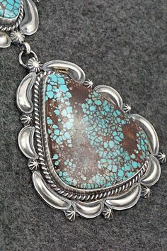 This stunning Egyptian turquoise and sterling silver pendant was made by Navajo silversmith Raymond Delgarito. The back is signed RD and stamped sterling.Length: 5 1/2"Width: 2 1/4"Free shipping on all orders! We ship with USPS and always include tracking. All orders ship within a day of payment.Returns are accepted up to 30 days after you receive your order. Just send us a message. Our shop offers cash back or store credit. The item must be returned in the same condition. Western Style Collectible Turquoise Sterling Silver Necklace, Collectible Sterling Silver Turquoise Necklace With Patina, Southwestern Turquoise Sterling Silver Collectible Necklace, Southwestern Silver Turquoise Necklace With Patina, Southwestern Sterling Silver Turquoise Necklace Collectible, Sterling Silver Turquoise Necklace With Patina, Collectible Southwestern Turquoise Pendant Necklace, Southwestern Untreated Turquoise Collectible Necklace, Southwestern Turquoise Pendant Necklace