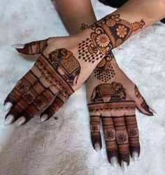 two hands with henna designs on them