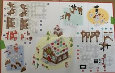 a cross stitch book with pictures of houses and animals on the pages, including an ornament