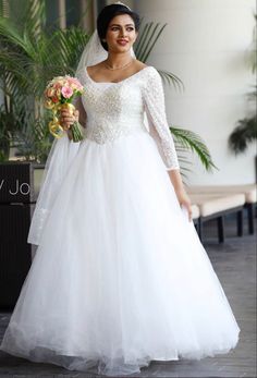 a woman in a wedding dress holding flowers