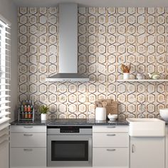 a kitchen with white cabinets and an oven in the center, surrounded by wallpaper