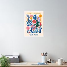 a flower market poster hangs on the wall above a desk