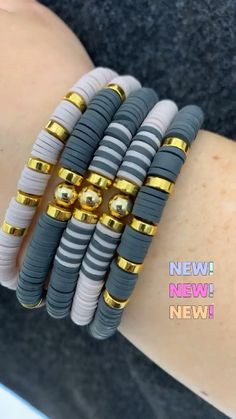 the bracelets are stacked on top of each other with gold and silver beads in them