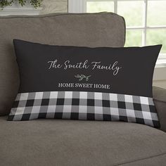 a black and white pillow sitting on top of a couch next to a window with the words, the south family home sweet home