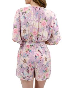 Purple Floral Sweetest Floral Romper | Purple Romper Be special occasion ready this summer with the new Purple Floral Sweetest Floral Romper! Its effortlessly elegant body style features flowy sleeves and an elastic waistband to give you all the comfort you need to breeze through your day. Meanwhile the eye-catching floral design and waist tie create an ultra-flattering silhouette. Whether you’re enjoying mother's day dinner or a baby shower, this floral romper is guaranteed to elevate your ward Spring Short Sleeve Daywear Jumpsuits And Rompers, Spring Short Sleeve Jumpsuits And Rompers For Daywear, Spring Daywear Jumpsuits And Rompers With Short Sleeves, Spring Daywear Jumpsuits With Short Sleeves, Spring Daywear Short Sleeve Jumpsuits And Rompers, Spring Flowy Loungewear Jumpsuits And Rompers, Flowy Spring Loungewear Jumpsuits And Rompers, Chic Flowy Jumpsuits And Rompers With Floral Print, Spring Loungewear Jumpsuits And Rompers, Flowy Fit