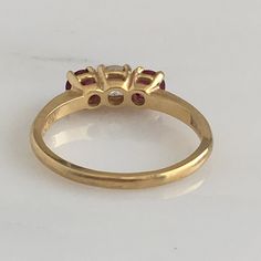 Details: Lovely Mid Century 18K yellow gold diamond and ruby ring, with two rubies and a diamond. Please ask all necessary questions prior to placing an order. Measurements: The size is 5 3/4 US and can be sized for a fee. Condition: The overall all condition of this ring is very good. Luxury Three Stone Ruby Ring, Classic Three Stone Ruby Ring With Diamonds, Classic Three-stone Ruby Ring, Classic Three Stone Ruby Ring, Fine Jewelry Yellow Gold Diamond Ring With Lab-created Ruby, Yellow Gold Diamond Ring With Lab-created Ruby Center Stone, Classic Yellow Gold Ruby Ring With Lab-created Ruby, Formal Ruby Three Stone Ring With Diamonds, Yellow Gold Diamond Ring With Lab-created Ruby